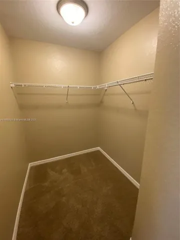 a view of a livingroom with a ceiling fan window and chandelier fan