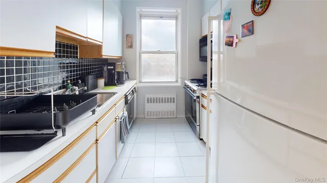 a kitchen with a sink stove and refrigerator