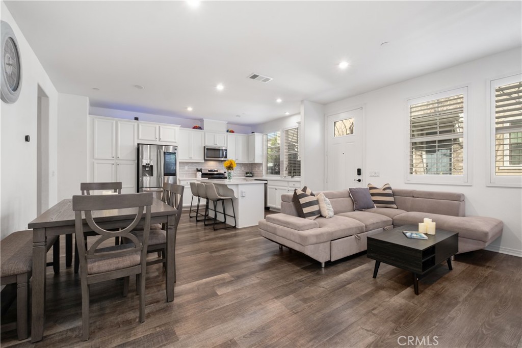 166 Natal Road Rancho Mission Viejo, CA 92694 - Photo 9 of 56 a living room with lots of furniture and kitchen view