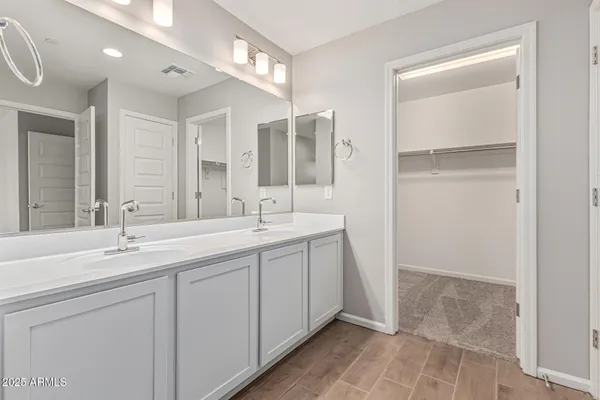 a bathroom with a double vanity sink mirror and double
