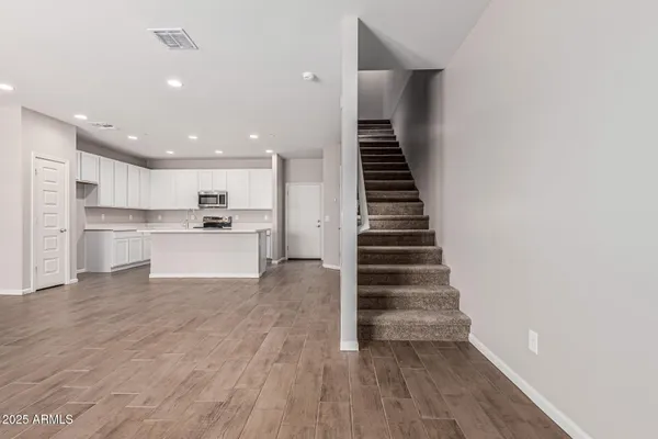 a view of kitchen with sink and refrigerator