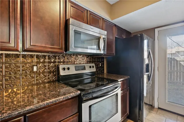 a stove top oven sitting inside of a kitchen