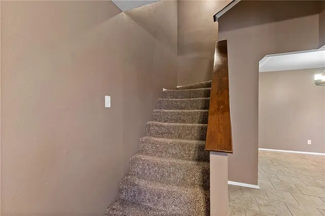 a view of staircase with white walls