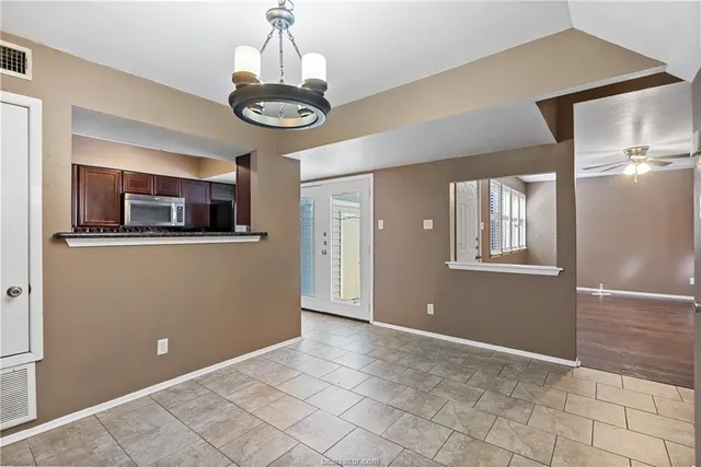 a view of a kitchen with an empty space and a window