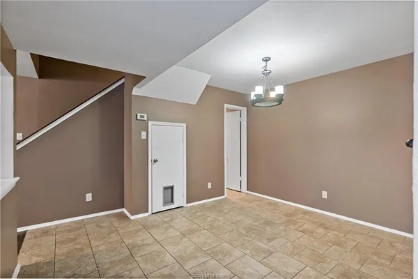a view of a chandelier in big room and hallway