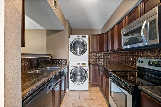 a utility room with sink dryer and washer