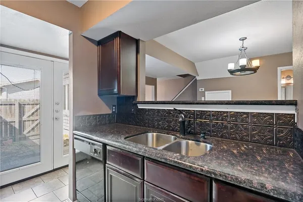 a kitchen with a sink and cabinets