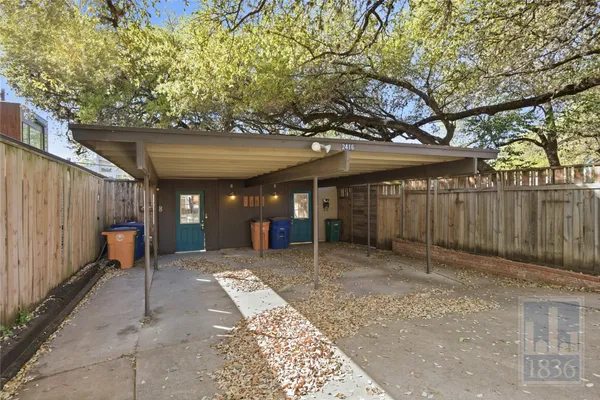 a view of a house with a tree in the background