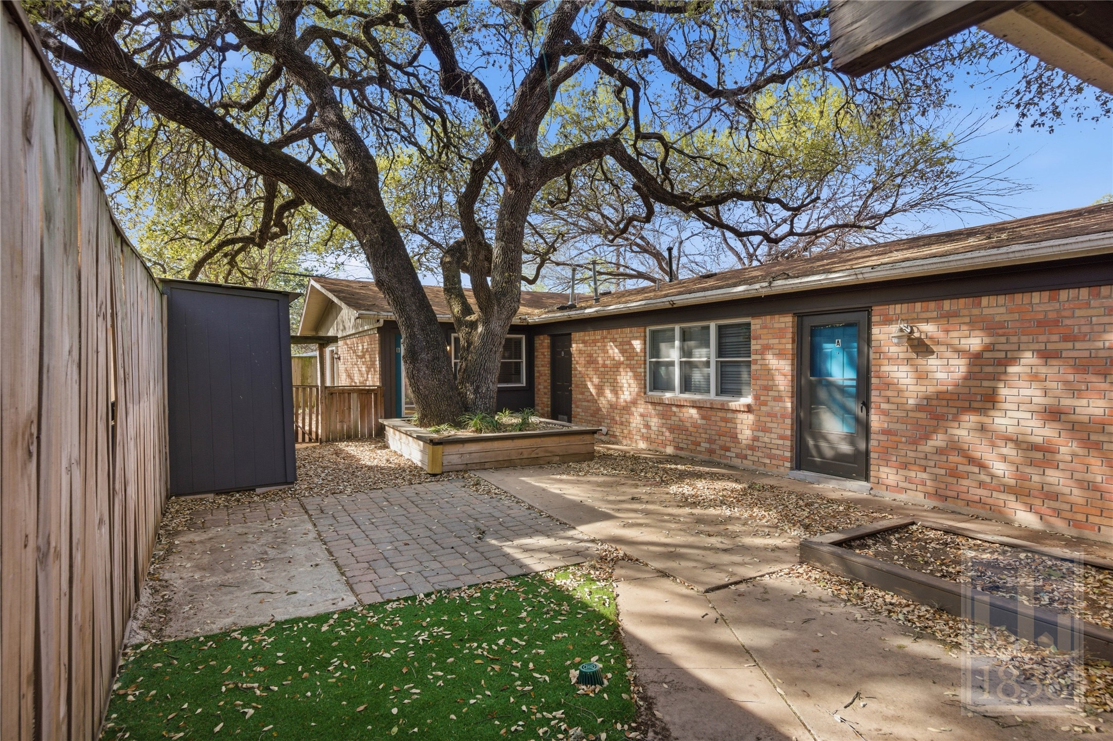 2416 South 5th Street, Unit B Austin, TX 78704 - Photo 23 of 28 a view of a house with a large tree and wooden fence