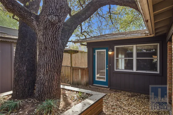 a view of a house with a tree in the background