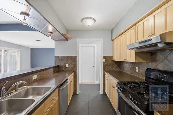 a kitchen that has a sink and a stove
