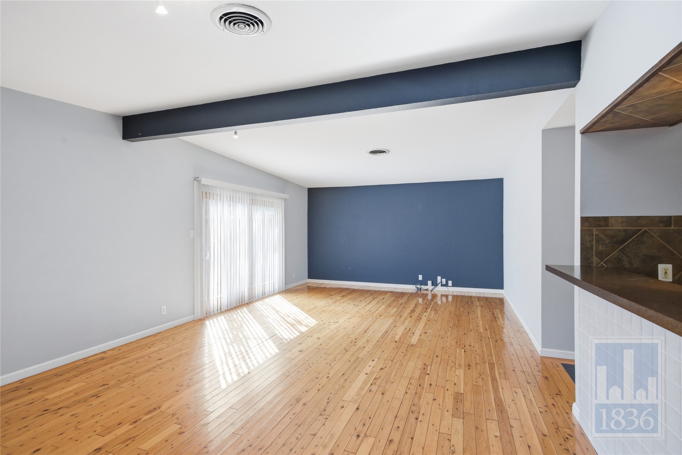 2416 South 5th Street, Unit B Austin, TX 78704 - Photo 6 of 28 a view of an empty room with wooden floor and a window