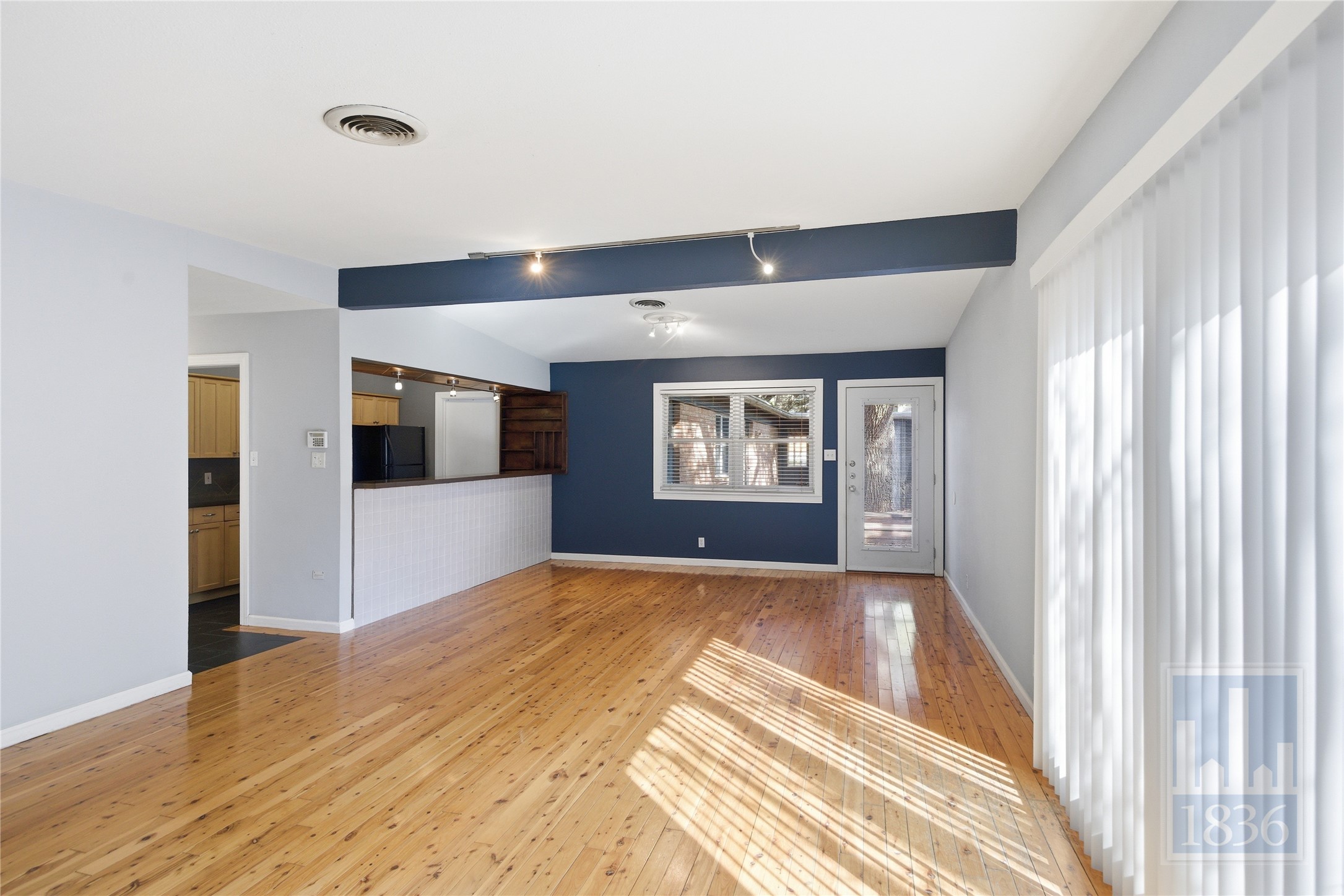 2416 South 5th Street, Unit B Austin, TX 78704 - Photo 7 of 28 a view of a hallway with wooden floor and a living room