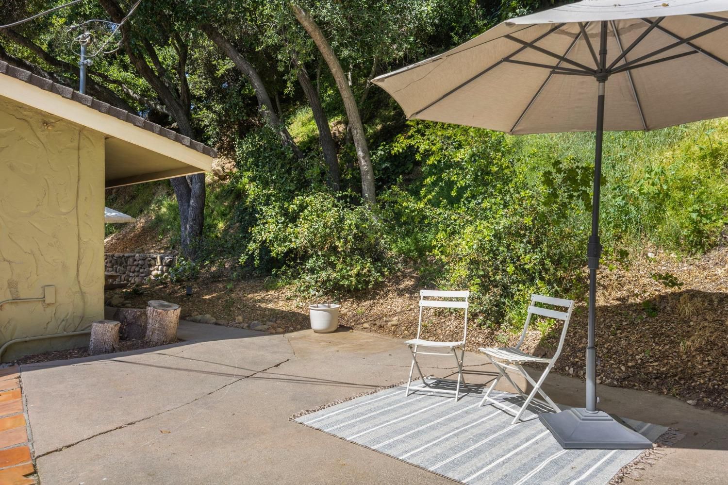 80 High Street Oak View, CA 93022 - Photo 32 of 93 a patio with a table and chairs under an umbrella