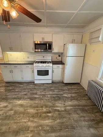 a kitchen with stainless steel appliances a refrigerator and a stove top oven