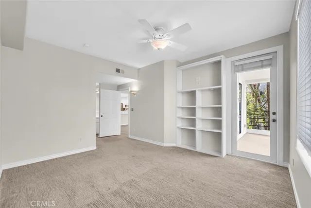 a view of an empty room with a ceiling fan