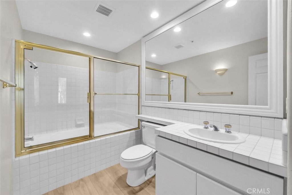 2243 Martin Irvine, CA 92612 - Photo 32 of 36 a bathroom with a granite countertop sink a toilet and shower