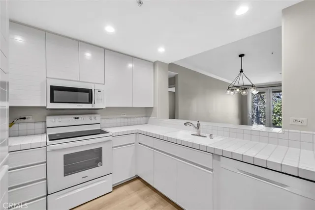 a kitchen with a sink stove and microwave