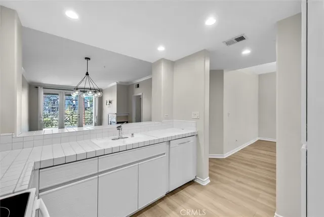 a bathroom with a sink mirror and a shower