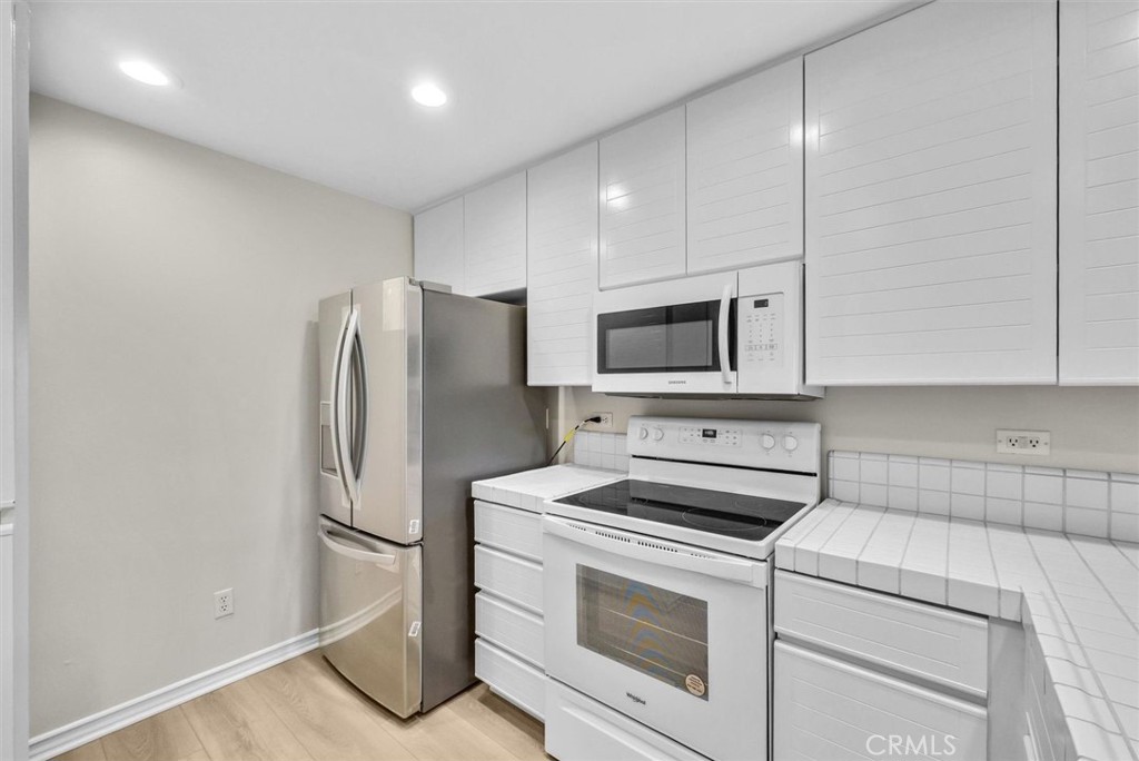 2243 Martin Irvine, CA 92612 - Photo 6 of 36 a kitchen with a refrigerator sink and cabinets