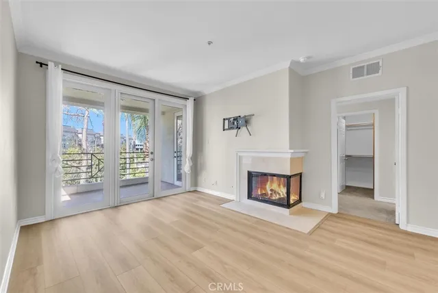 a view of an empty room with a fireplace and a window