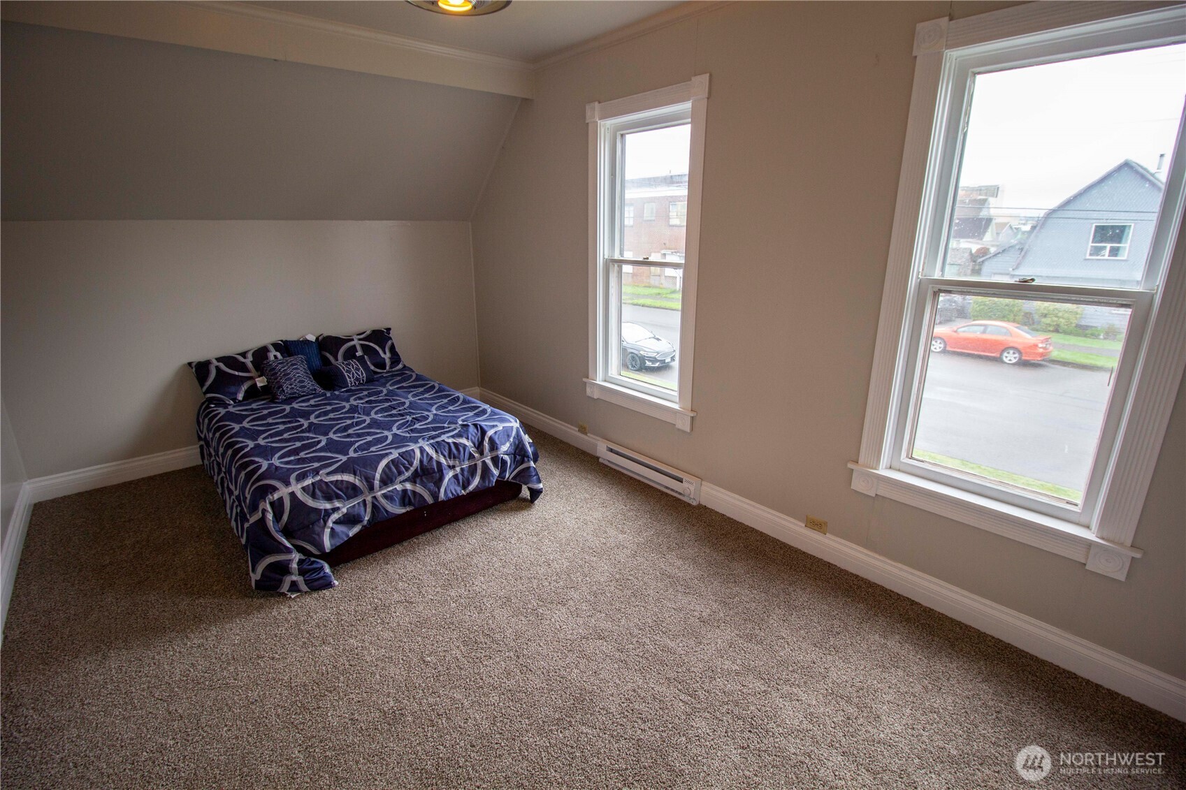 412 5th Street Hoquiam, WA 98550 - Photo 12 of 17 a bedroom with a bed and a window