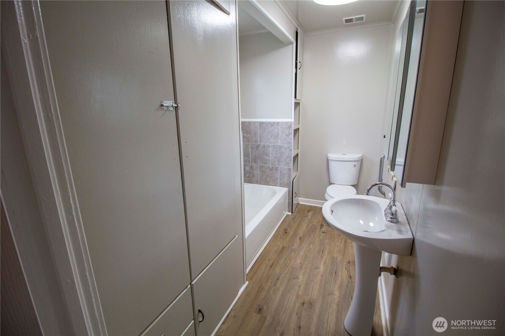412 5th Street Hoquiam, WA 98550 - Photo 13 of 17 a bathroom with a sink a toilet and shower