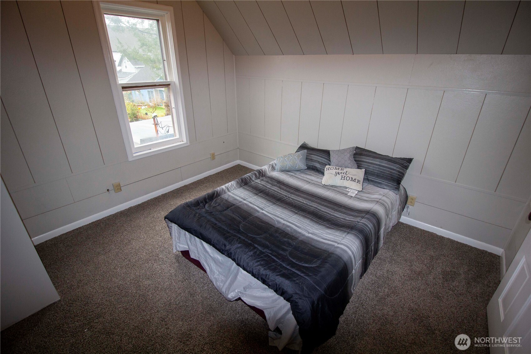 412 5th Street Hoquiam, WA 98550 - Photo 8 of 17 a bedroom with a bed and a window