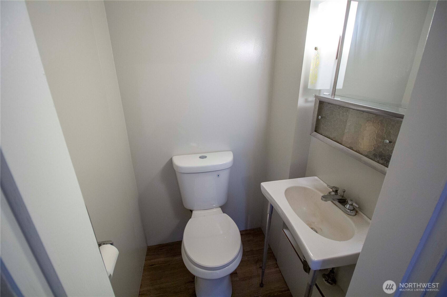 412 5th Street Hoquiam, WA 98550 - Photo 9 of 17 a white toilet sitting next to a bathroom sink