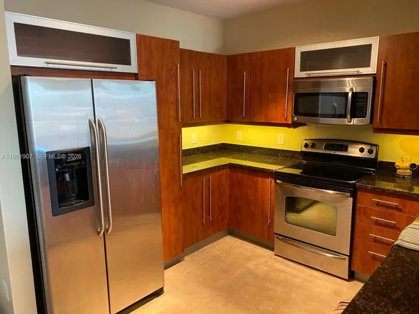 a kitchen with a refrigerator stove and microwave
