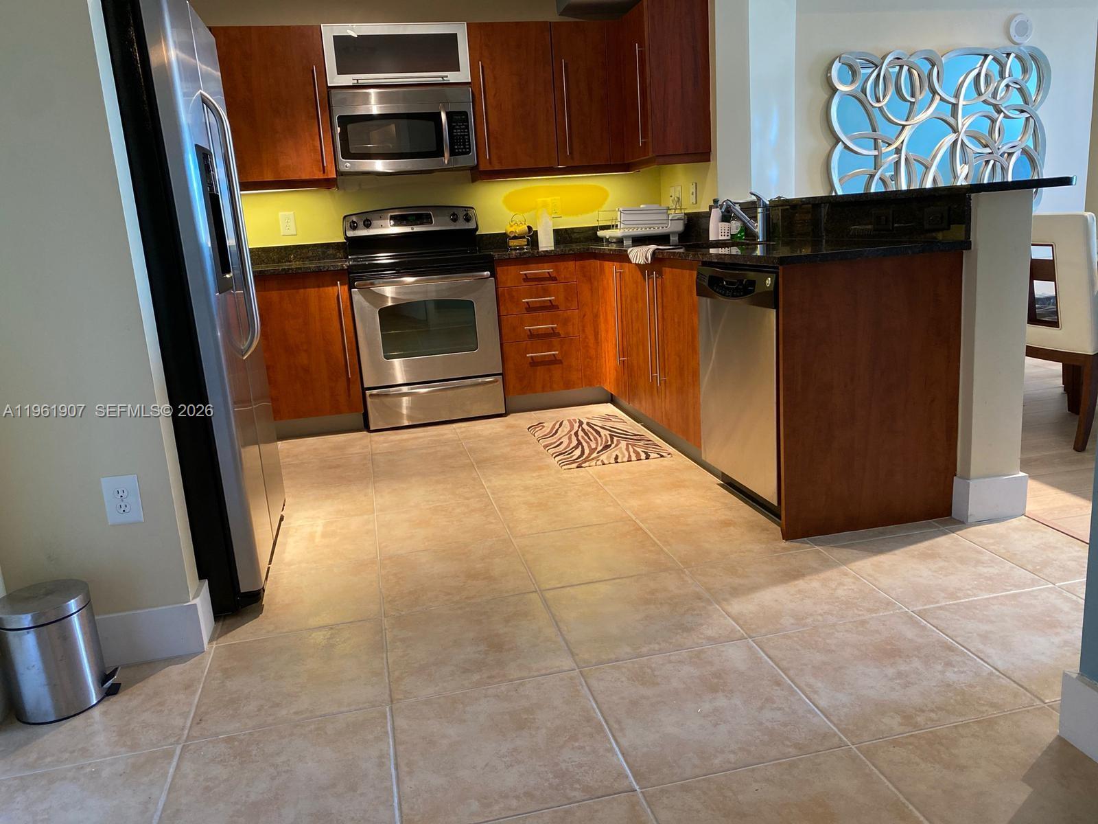 7350 Southwest 89th Street, Unit 2104S Miami, FL 33156 - Photo 14 of 30 a kitchen with a stove and a refrigerator