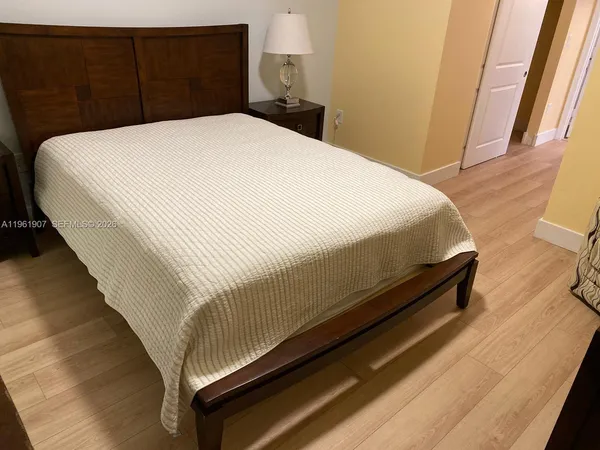 a bed sitting in a bedroom next to a window