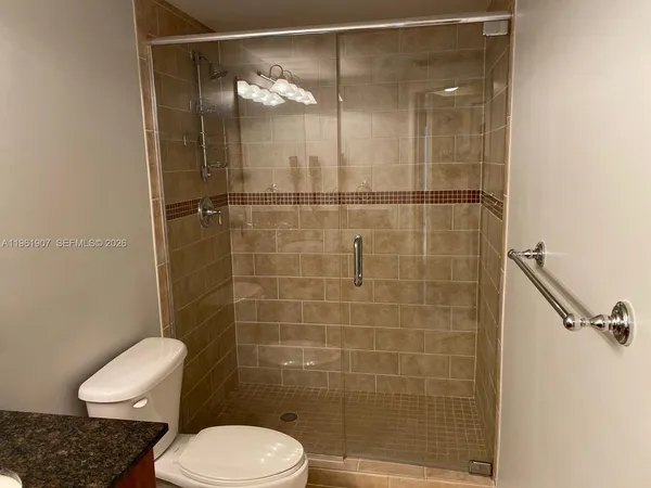a bathroom with a toilet and a shower