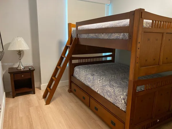 a bedroom with a bed and a mirror