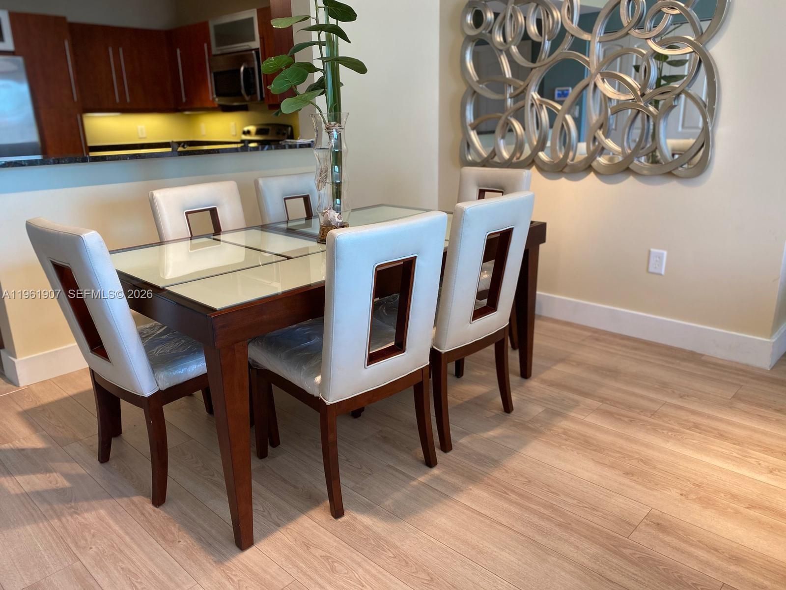 7350 Southwest 89th Street, Unit 2104S Miami, FL 33156 - Photo 9 of 30 a dining room with furniture and wooden floor