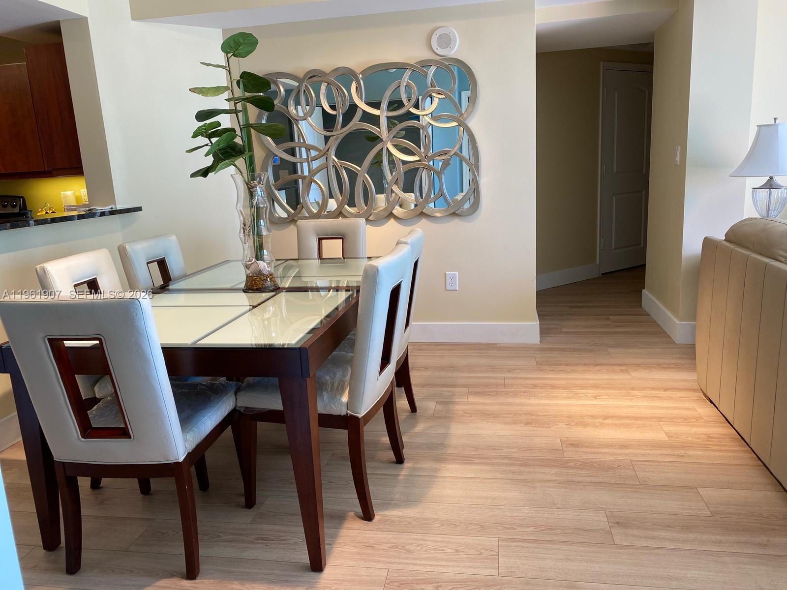 7350 Southwest 89th Street, Unit 2104S Miami, FL 33156 - Photo 10 of 30 a view of a dining room with furniture and wooden floor