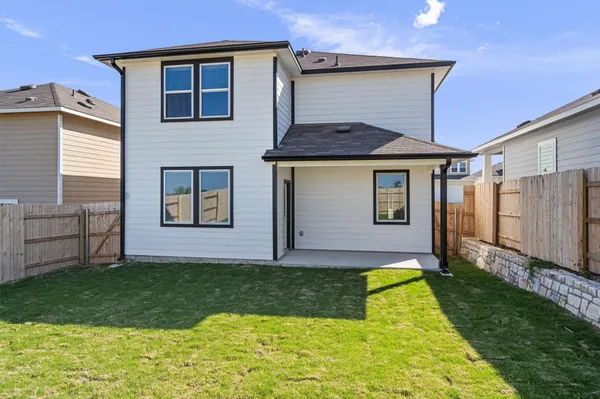 a view of a house with a backyard