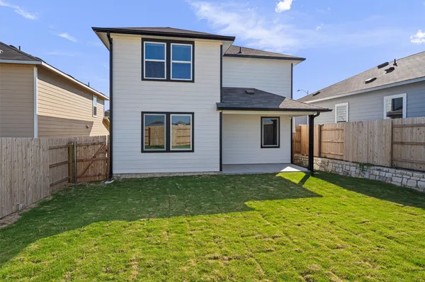 a view of a backyard with a garden and entertaining space