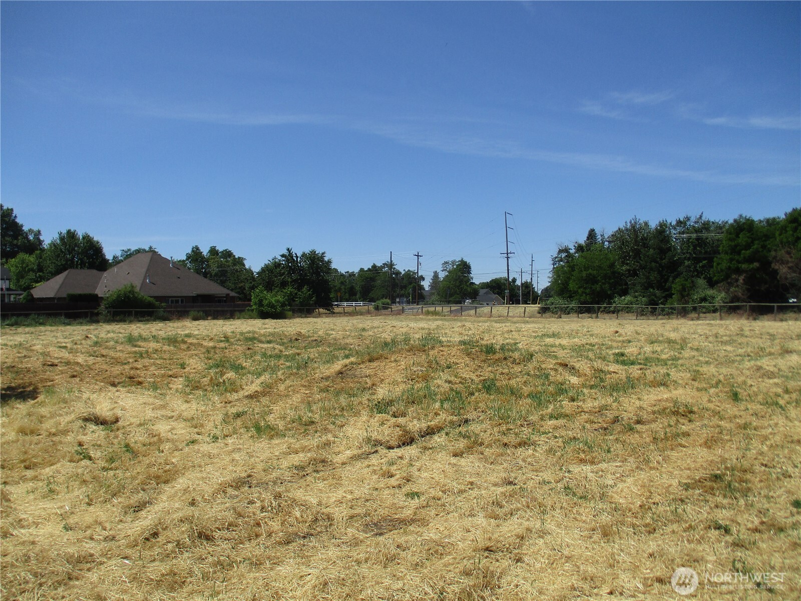2499 Cottonwood Road Walla Walla, WA 99362 - Photo 3 of 19 a view of a field with an trees in the background
