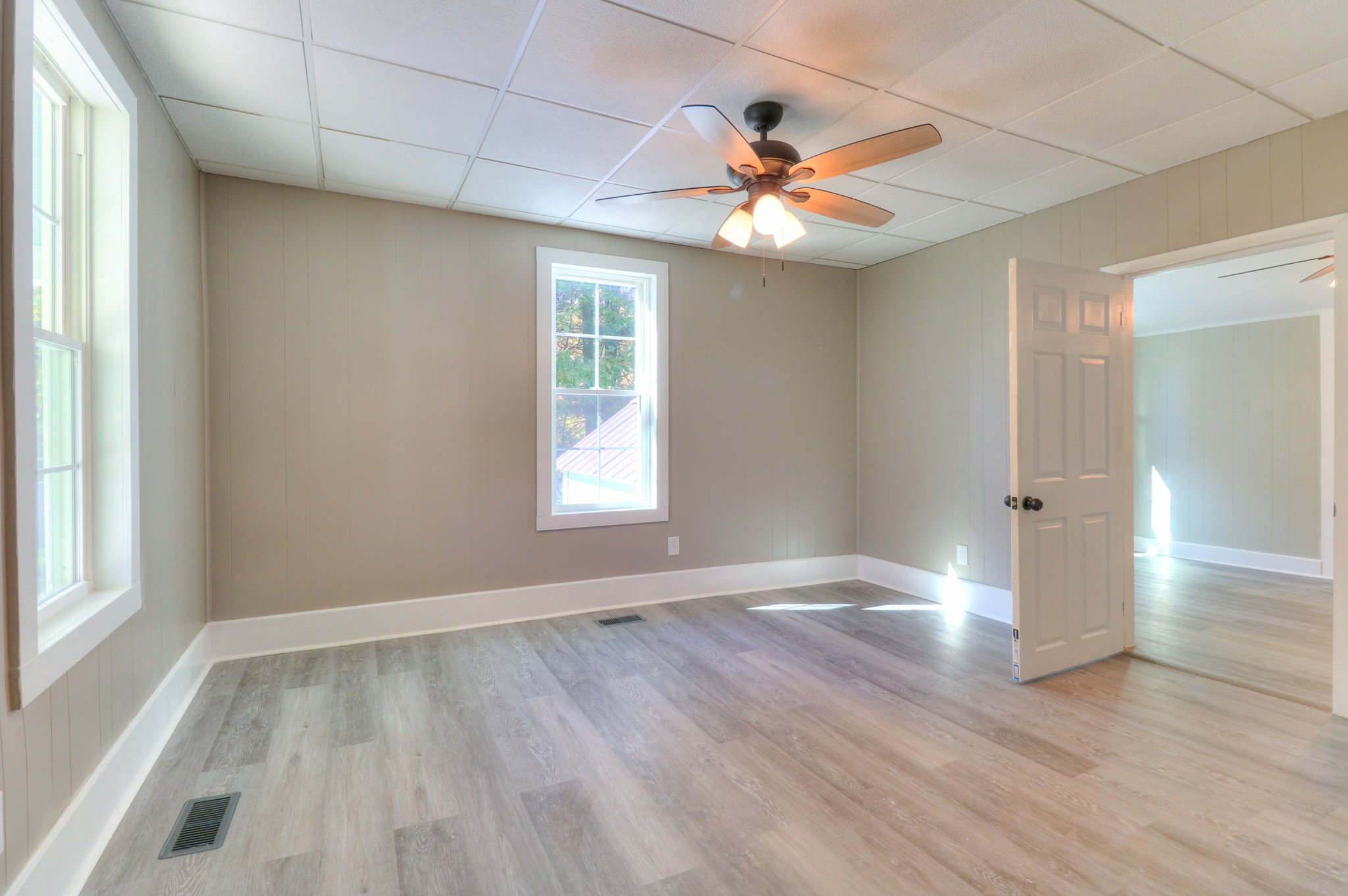 65 Duck Pond Road Palmer, TN 37365 - Photo 13 of 25 an empty room with wooden floor chandelier fan and windows