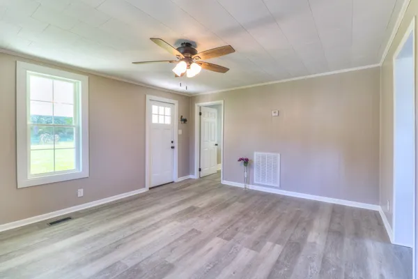 wooden floor in an empty room with a window
