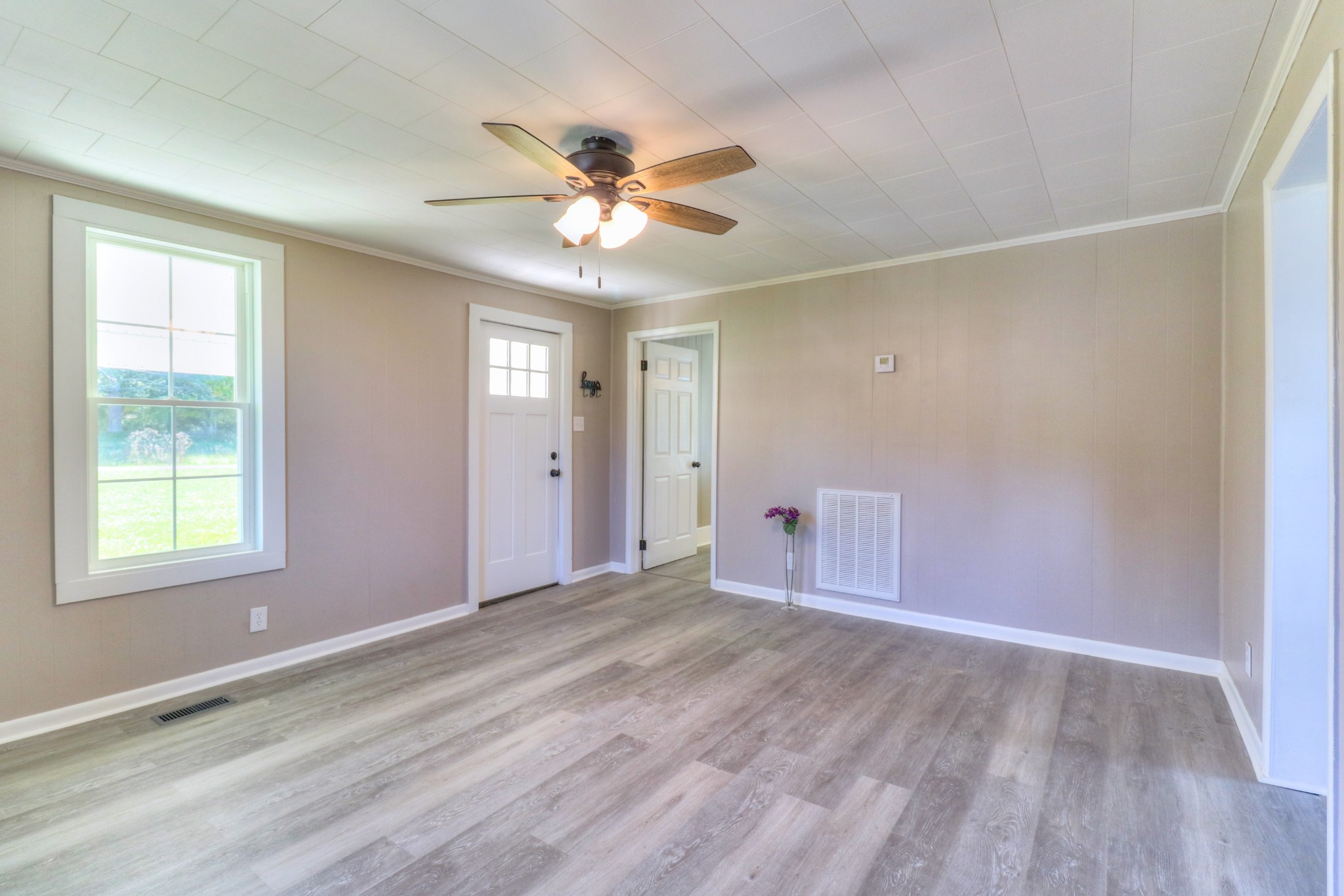 65 Duck Pond Road Palmer, TN 37365 - Photo 4 of 25 wooden floor in an empty room with a window