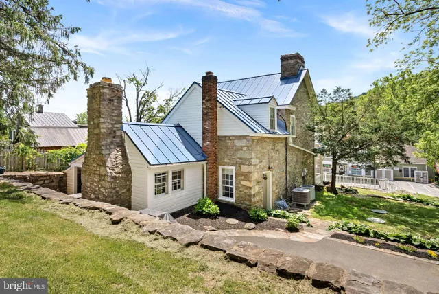 a house with green field in front of it