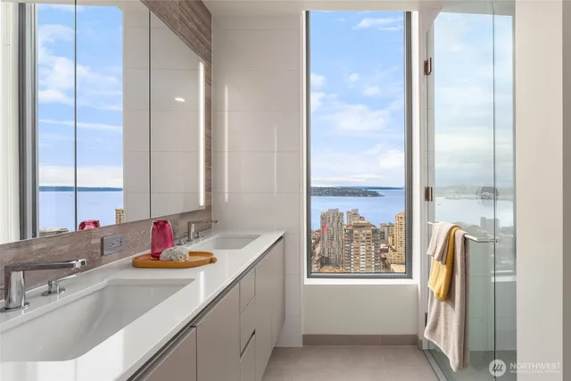 a bathroom with a tub sink and mirror