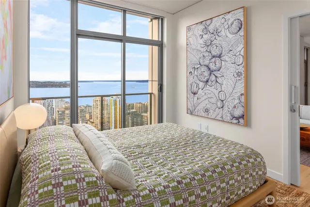 a bedroom with a large window and bed