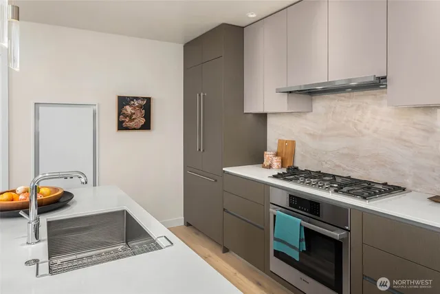 a kitchen with granite countertop a stove and a sink