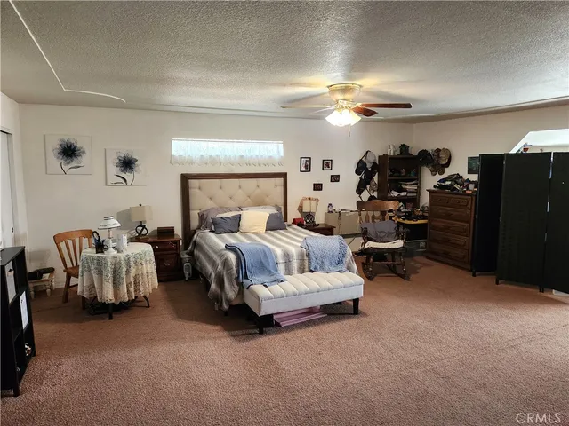 a bedroom with furniture and a lamp