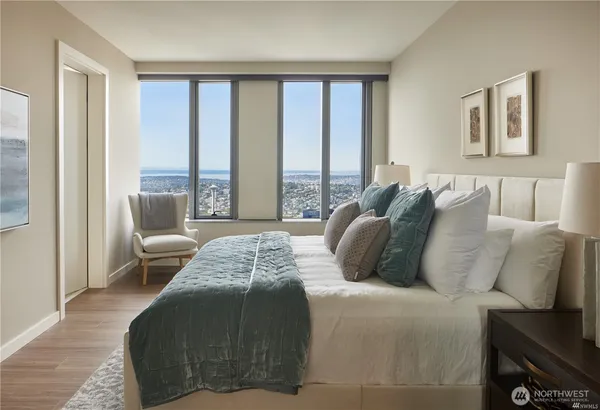 a bedroom with bed and a large window