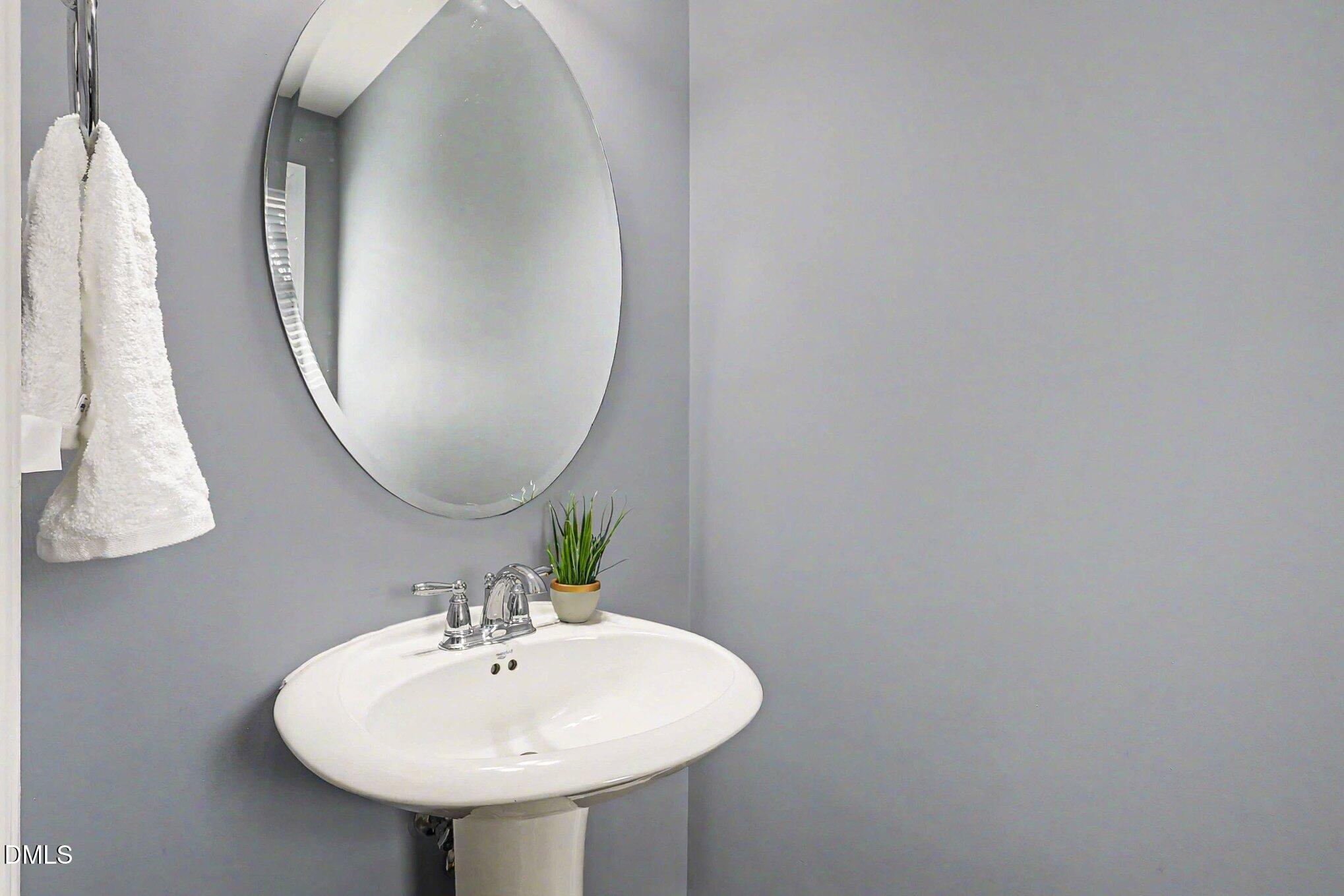 653 Fallon Grove Way Raleigh, NC 27608 - Photo 11 of 38 a bathroom with a sink and a mirror