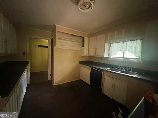 a kitchen with granite countertop a sink and a stove top oven
